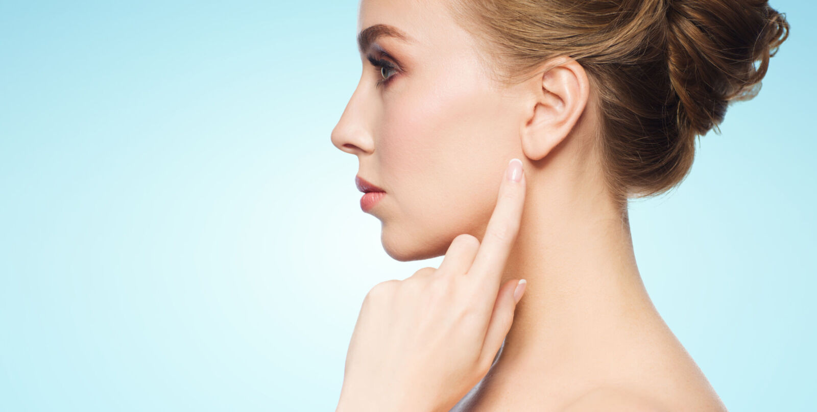 beautiful woman pointing finger to her ear